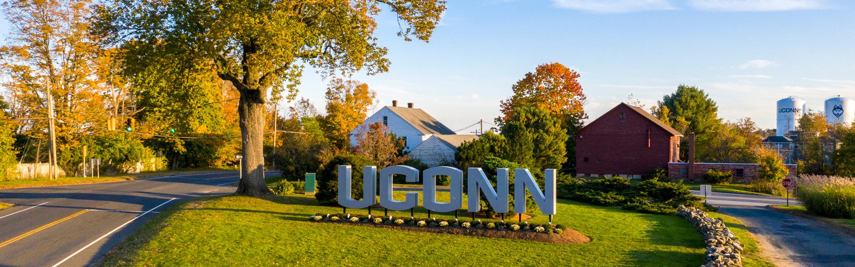 UCONN spelled out in large letters on green lawn.